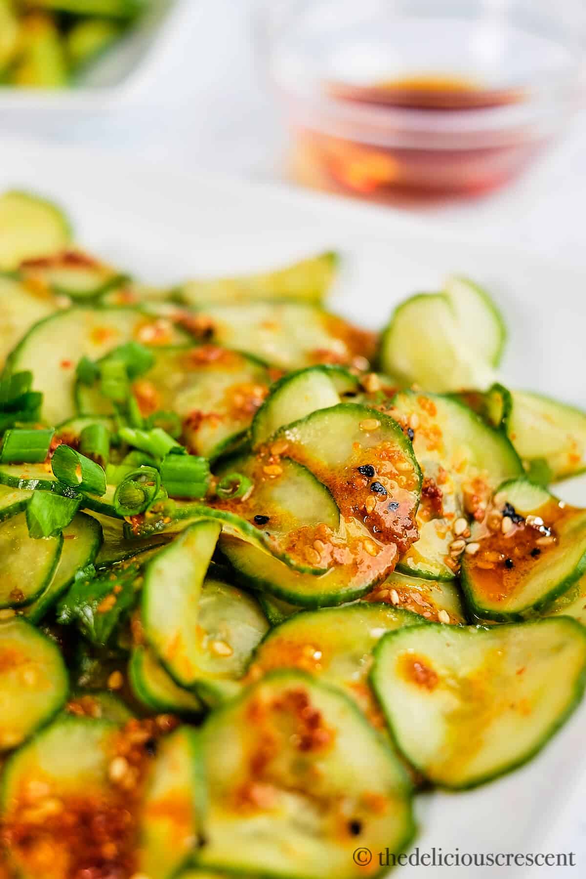 Pickled cucumber salad prepared in Asian style and served in a plate.