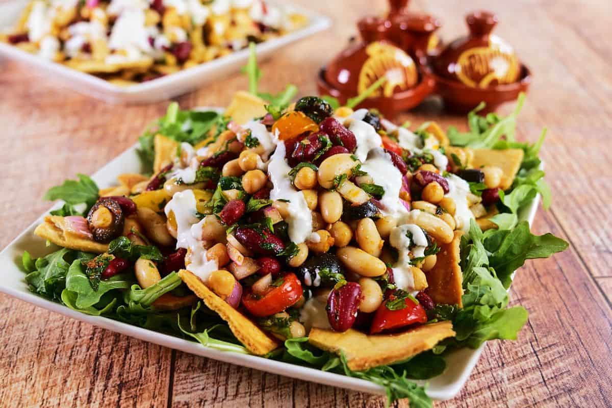 Mediterranean bean salad with feta dressing served on the table.
