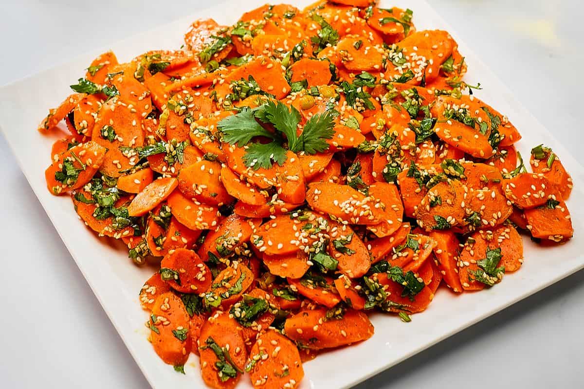 Vegan Moroccan carrot salad on a white plate.